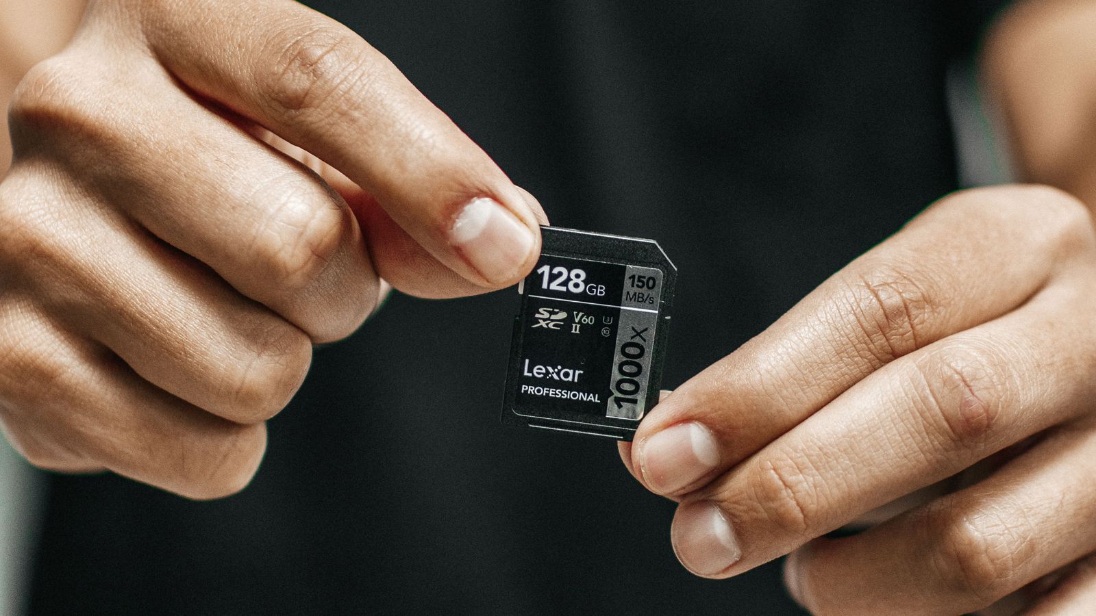 Dash cam SD card failure India 2026 - hands holding a 128GB memory card showing capacity and speed class markings, high endurance card check for dash cameras