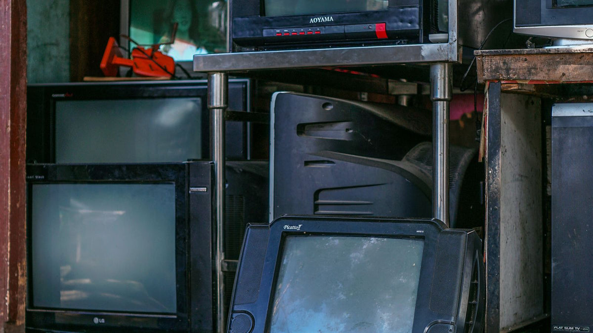 Buying used car accessories India 2026 - stacked second hand electronics in a used goods shop, unknown history and provenance when buying pre-owned car components