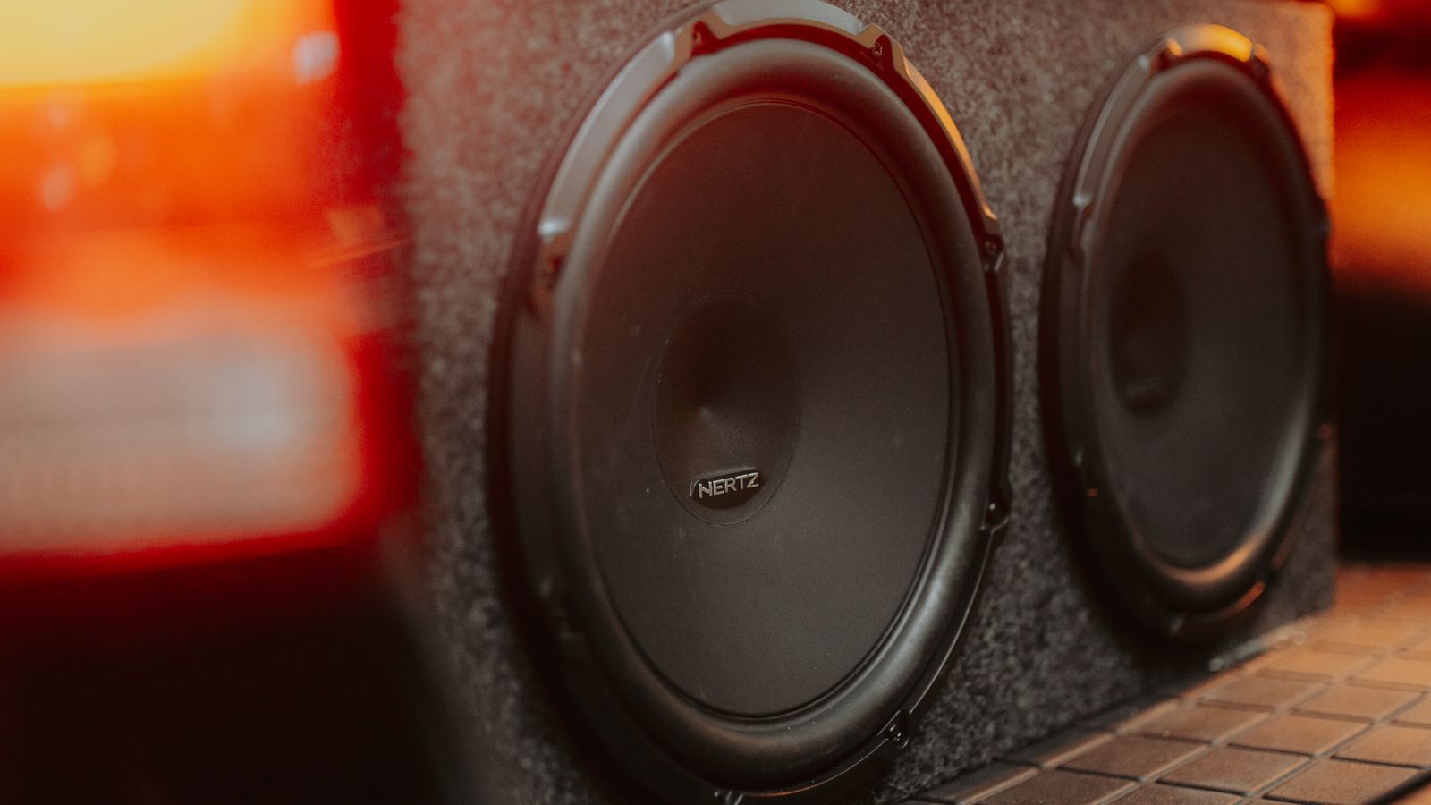 Car amplifier gain and clipping India 2026 - close up of car subwoofers mounted in a boot enclosure, amplifier gain setting and clipping damage to speakers