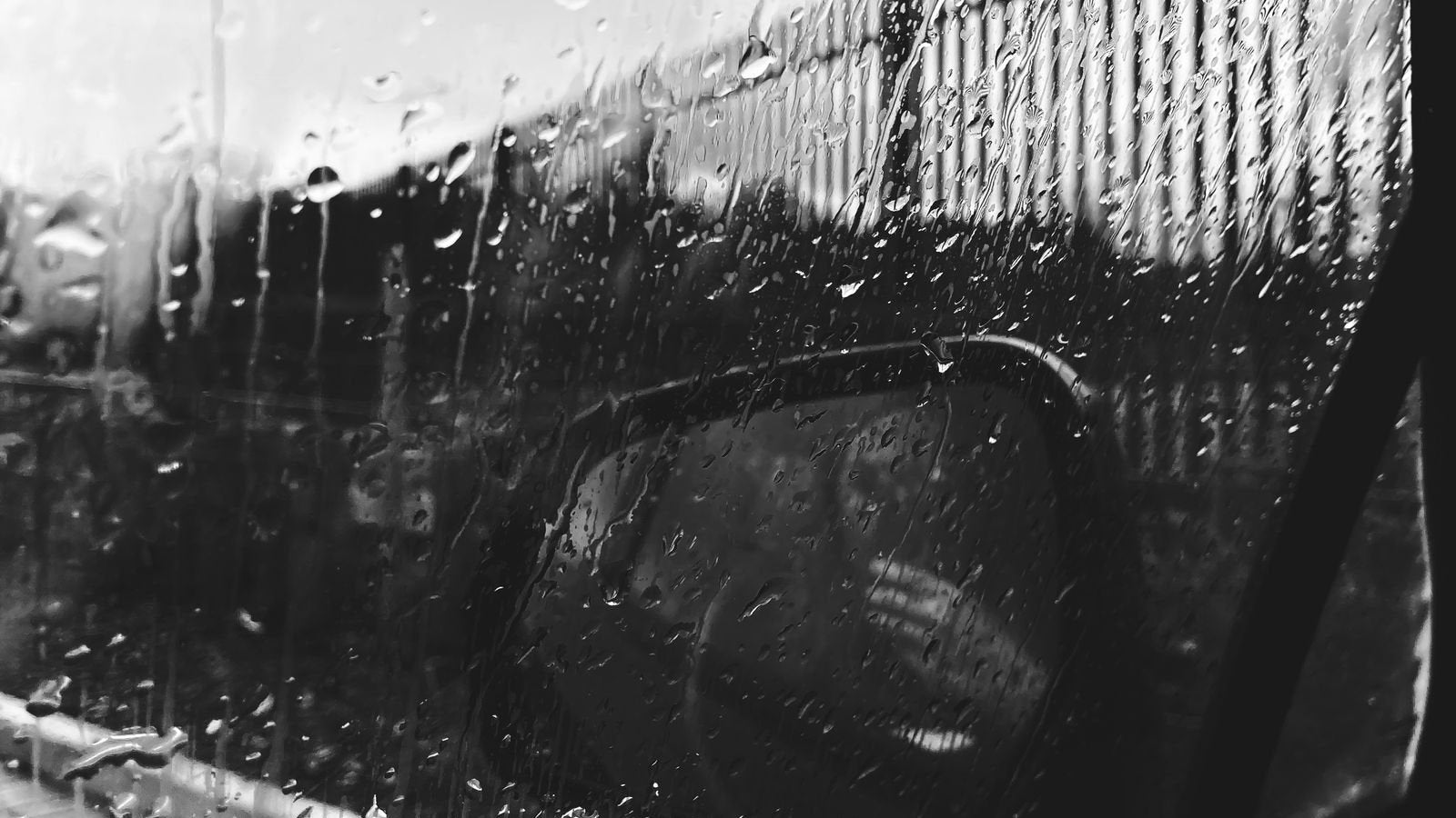 Rain and water droplets on a car rear window - why reverse and rear cameras fail in the Indian monsoon 2026, IP rating and waterproof wiring connector guide