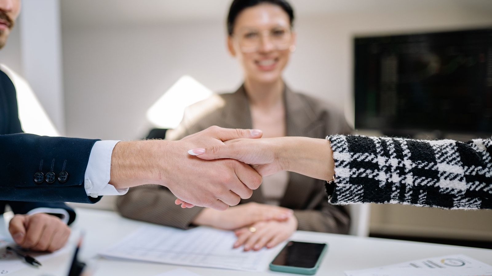 Two people shaking hands over a car deal - car accessories and resale value guide India 2026, what adds value versus what hurts resale