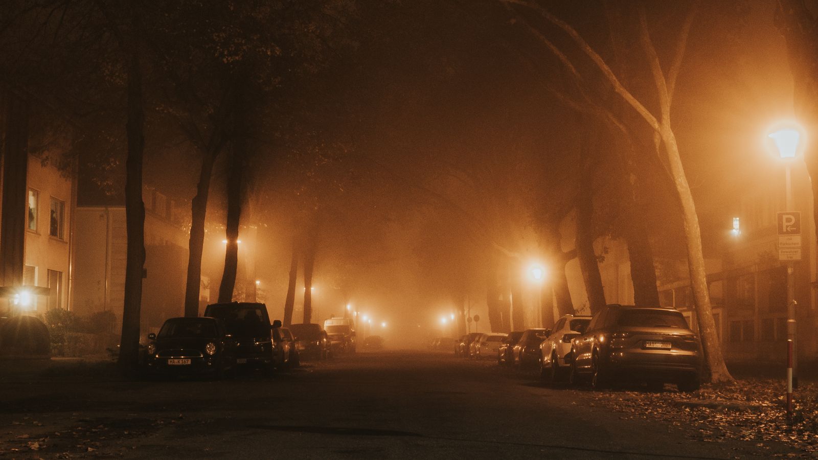 Car theft protection India 2026 - cars parked overnight on a dim foggy street under sodium streetlights, dash cam parking mode and 4G cloud evidence