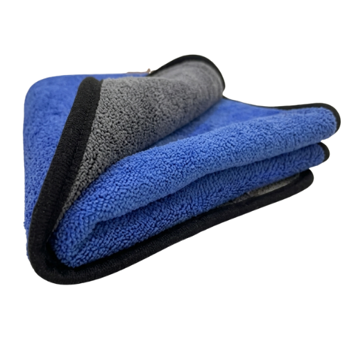Folded dual-sided 800 GSM microfiber car cleaning cloth showing the plush blue and grey sides with premium black stitched edges